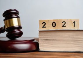 The concept of new laws in 2021 next to the judge hammer.