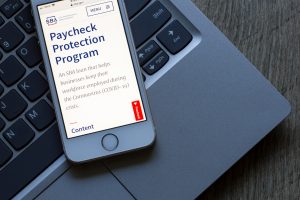The U.S. Small Business Administration website's Paycheck Protection Program (PPP) page is seen on a phone. PPP loan helps businesses keep their workforce employed.