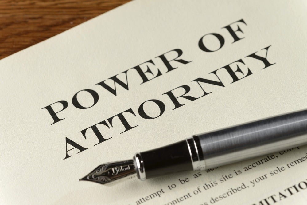 power of attorney document with silver fountain pen