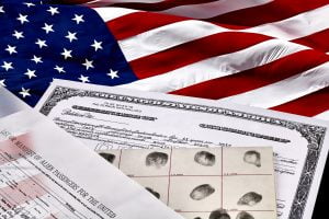 Certificate of US Citizenship, fingerprint card, Declaration of Intention and Passenger Manifest documents with American Flag