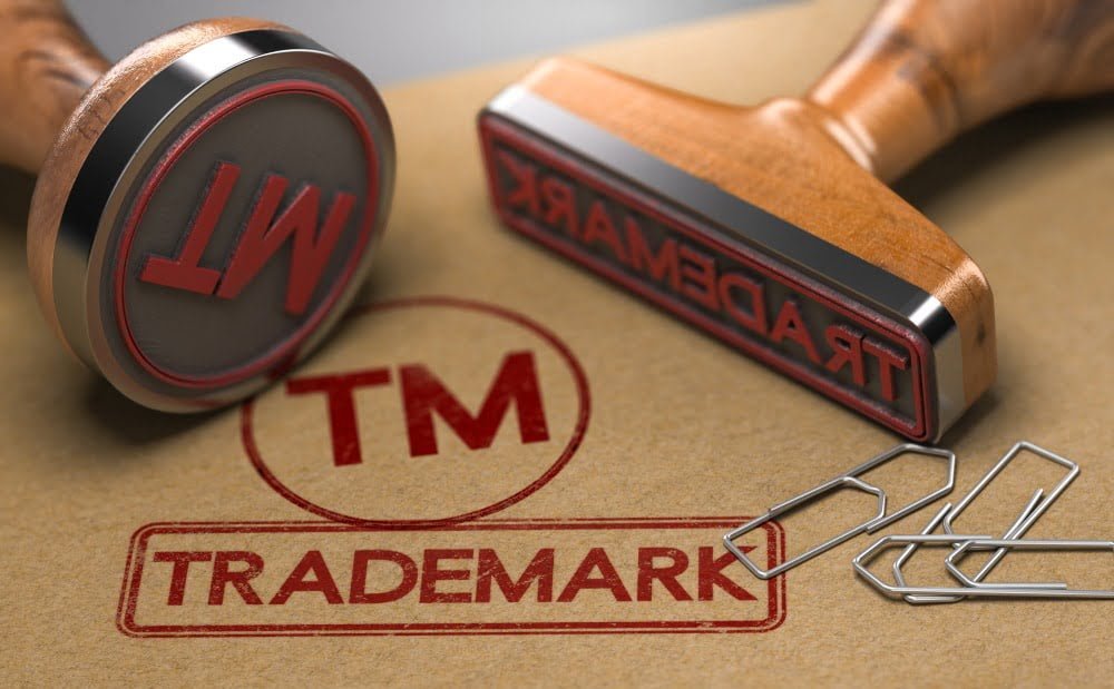 Trademark writing in red on brown wood